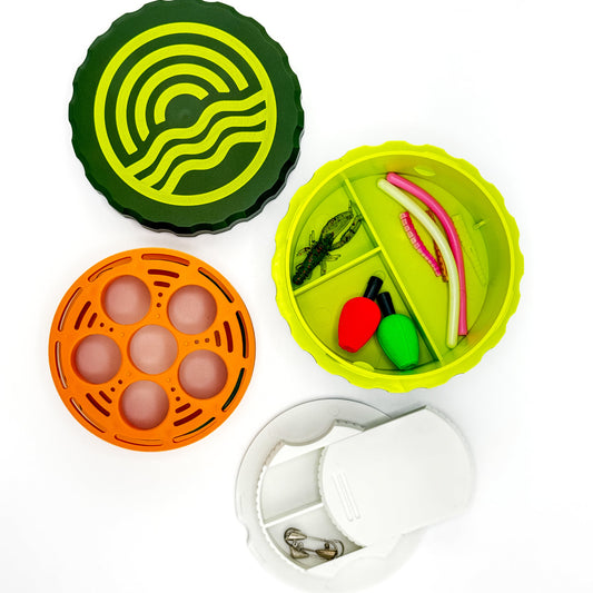 Fishing tackle box with various fishing lures and tools on a white background