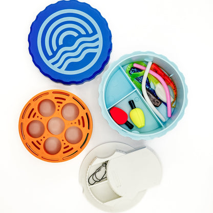 Collection of colorful containers with different compartments on a white background